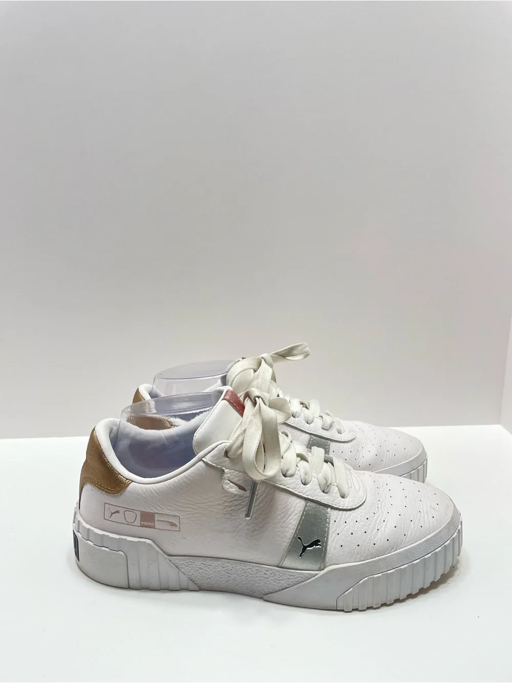 Women’s 7.5 Puma Cali Hacked White with gold and silver accents
